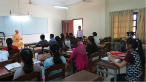 Lecture is going on.  The translator is standing at the corner near the door